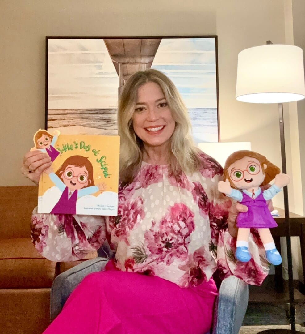 Woman holding children's book and matching doll